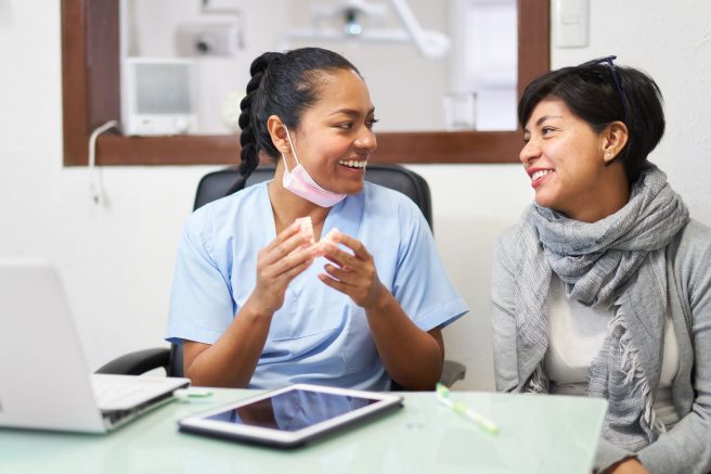 Happy Dentist With Her Patient